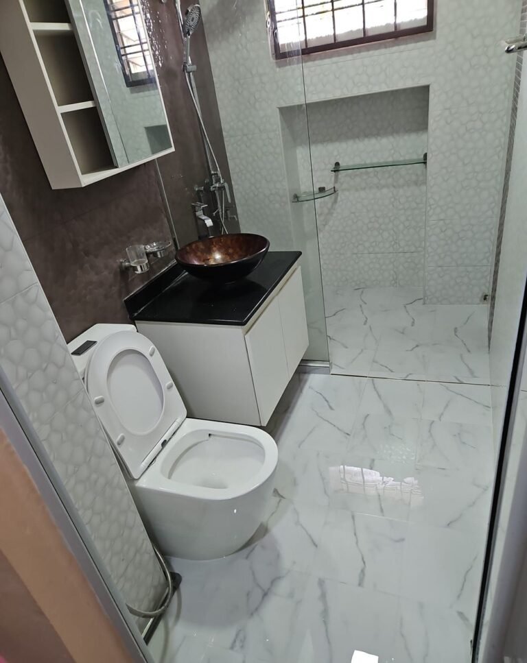 HDB toilet renovation with full-height wall tiling and wall-hung vanity