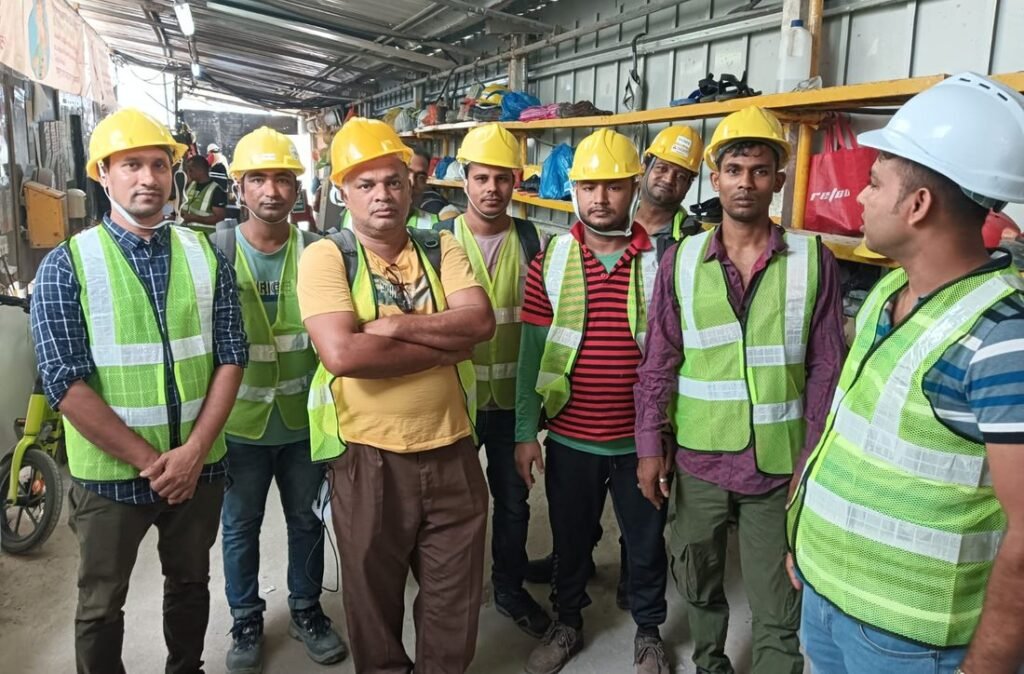 The LM Infinite Tech site team in company hi-vis vests and safety helmets in Singapore